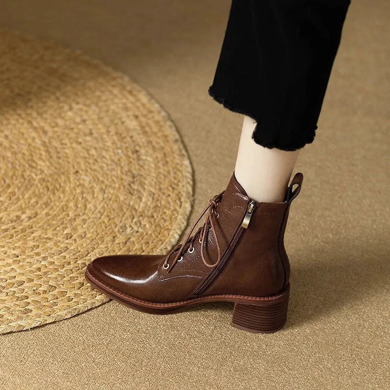 Women's black pointed toe short tube ankle boots with 5.5cm heel on wooden floor
