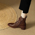 Women's black pointed toe short tube ankle boots with 5.5cm heel on wooden floor