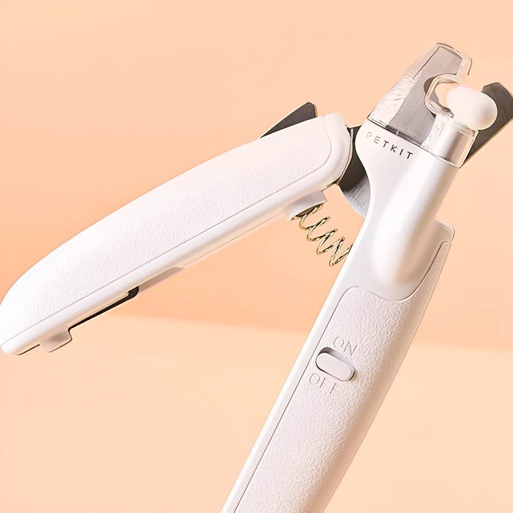 White pet nail clippers with LED light, transparent guard, and nail file for cats and dogs