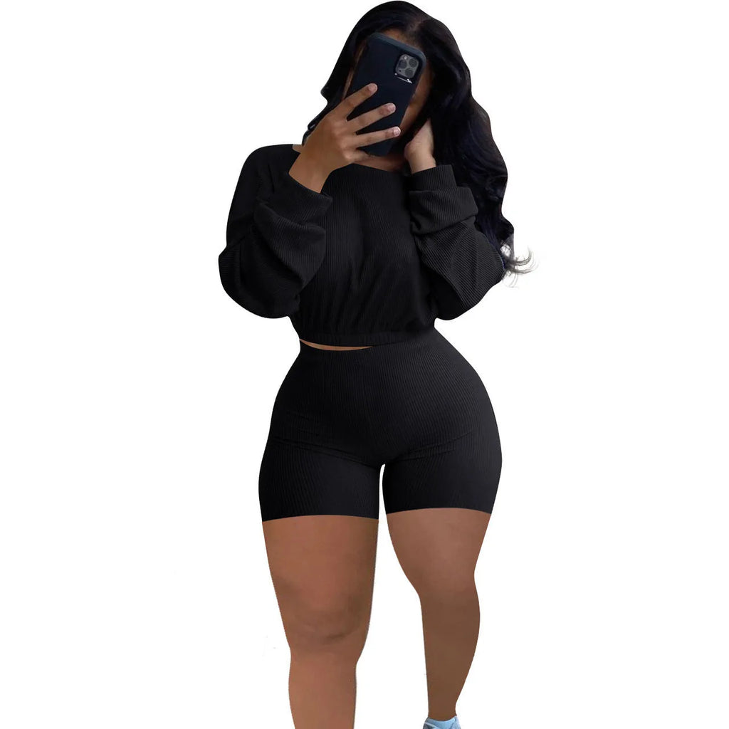 Sunken stripe solid colour off-the-shoulder long sleeve top and shorts two-piece set on a hanger.