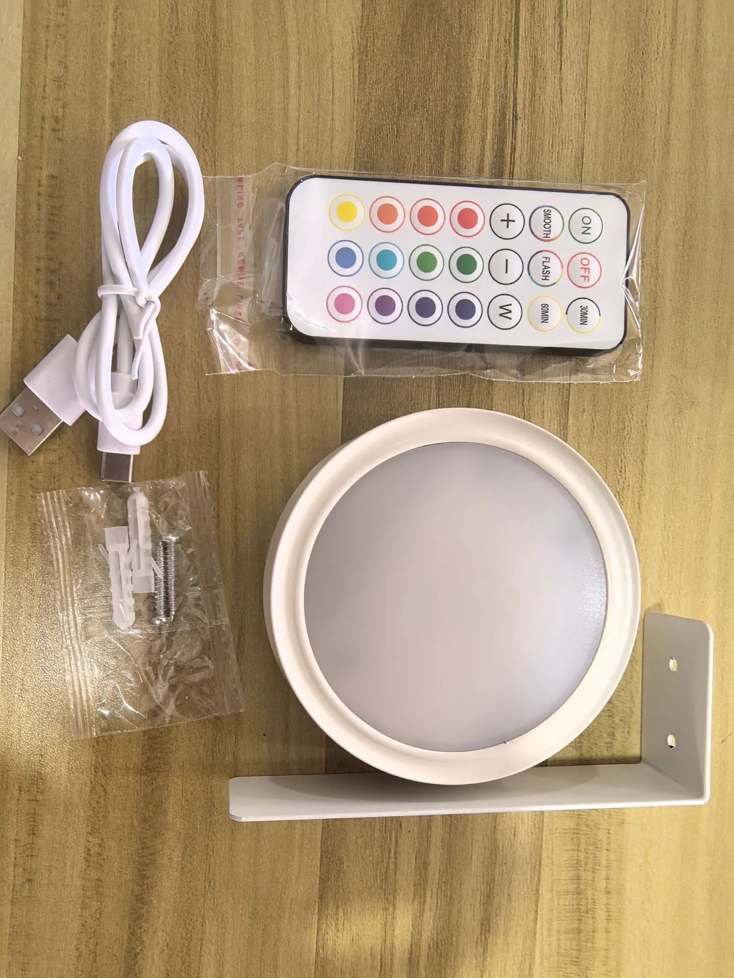 Wireless rechargeable LED painting lamp with magnetic belt attached to a metal frame, remote control nearby.