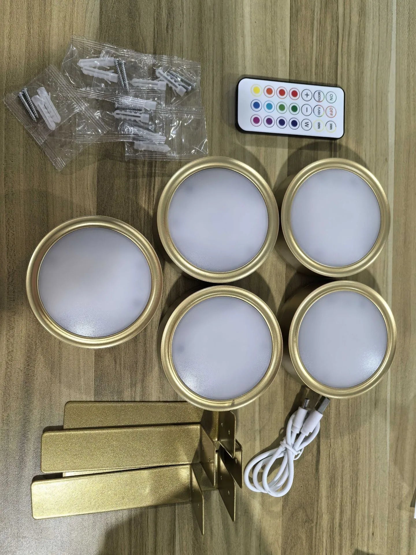 Wireless rechargeable LED painting lamp with magnetic belt attached to a metal frame, remote control nearby.