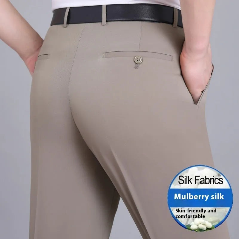 Man wearing dark blue straight-leg suit pants with a high waist, made from a non-ironing mulberry silk blend fabric.
