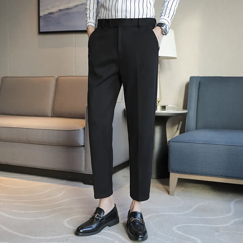 Men's brown straight-leg corduroy trousers with an elasticated waistband laid flat.