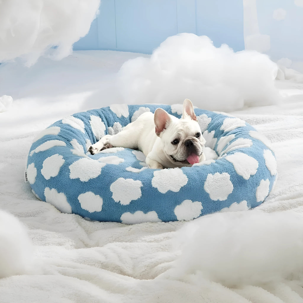 Round plaid-patterned dog bed on a floor, shown in a blue and white colour variant.