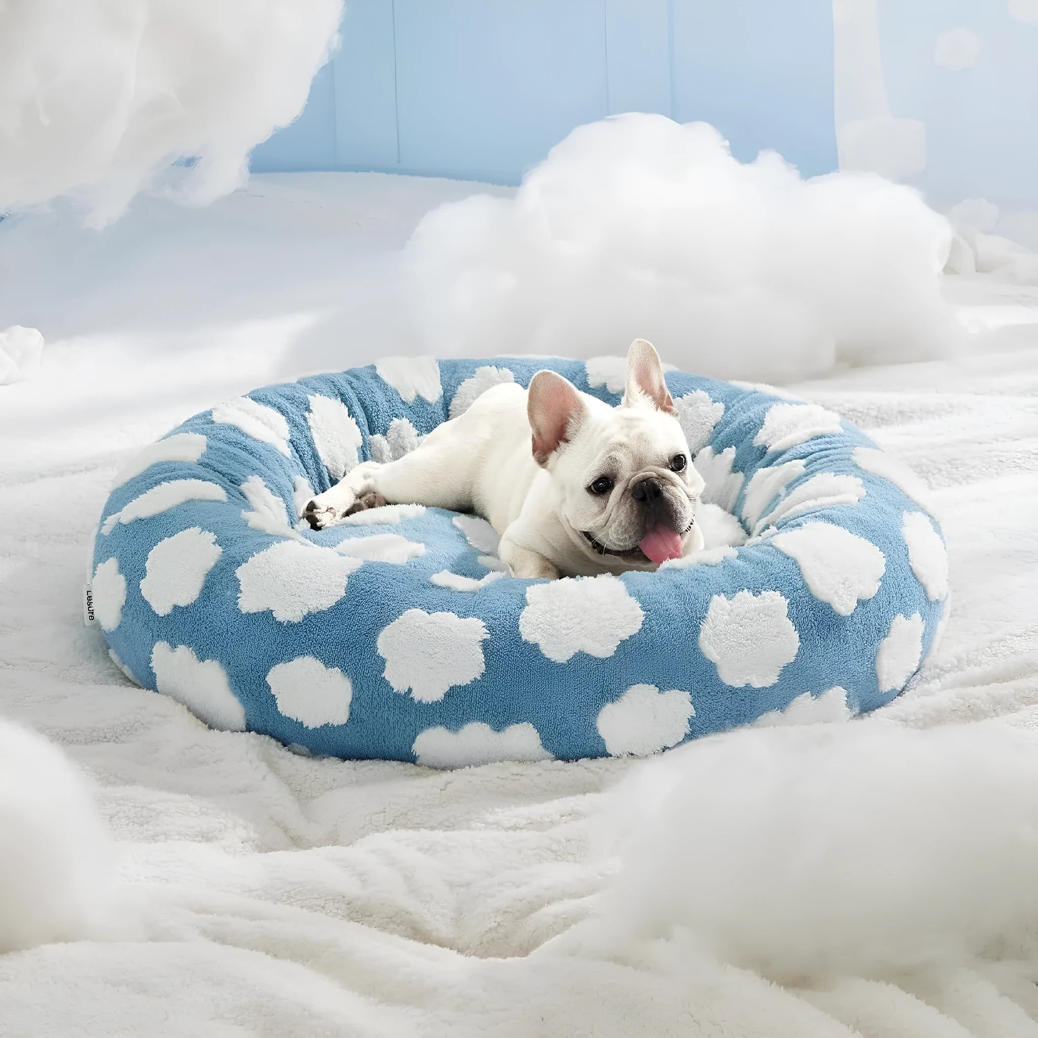 Round plaid-patterned dog bed on a floor, shown in a blue and white colour variant.