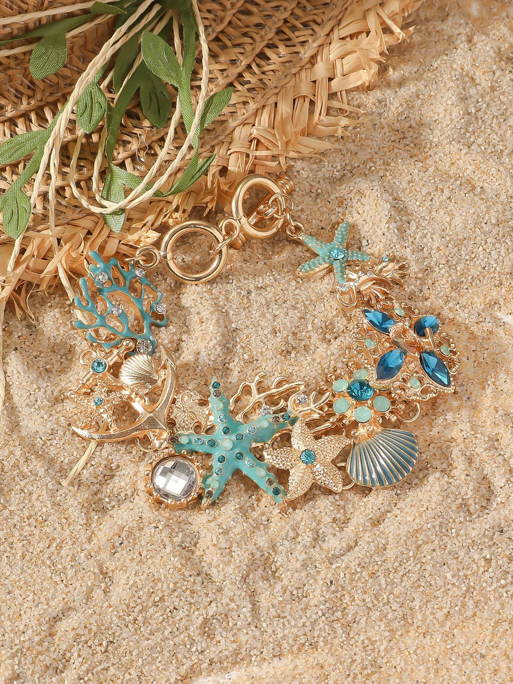 Women's alloy bracelet with a rhinestone-studded boat anchor and starfish charm in blue, red, or turquoise.
