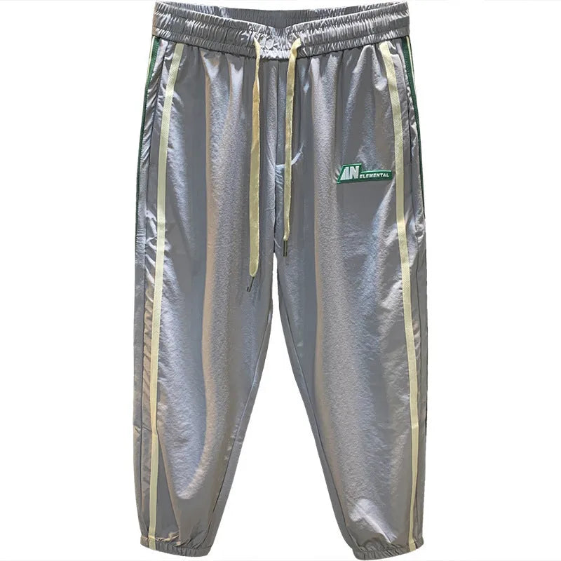 Men's solid colour cotton harem pants in black or grey, showing mid-waist and straight leg design
