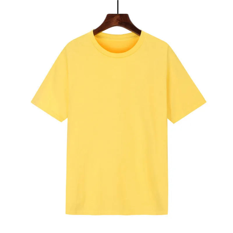 Man wearing a black loose-fit cotton T-shirt with short sleeves, showcasing casual style.