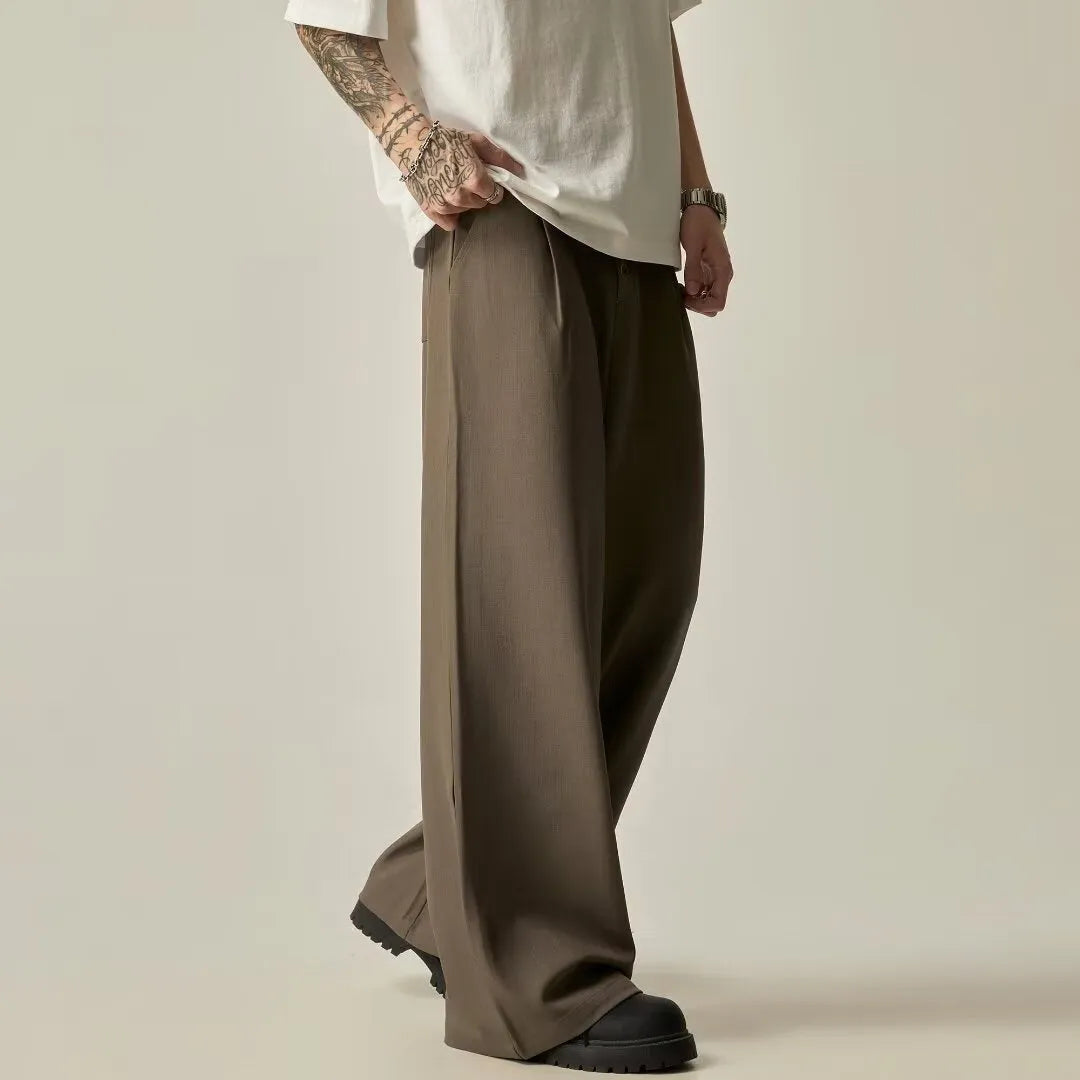 Men's black wide-leg casual trousers with elasticated mid waist and button fly in polyester-cotton blend fabric
