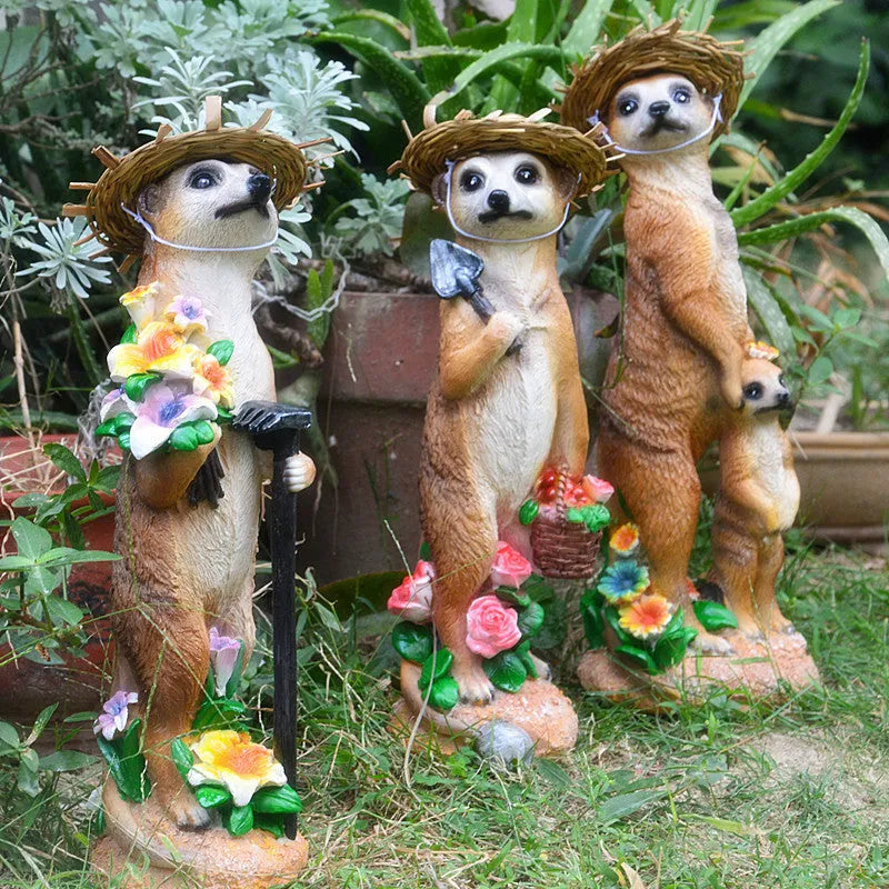 Resin mongoose garden ornament with straw hat and garden tool accessory