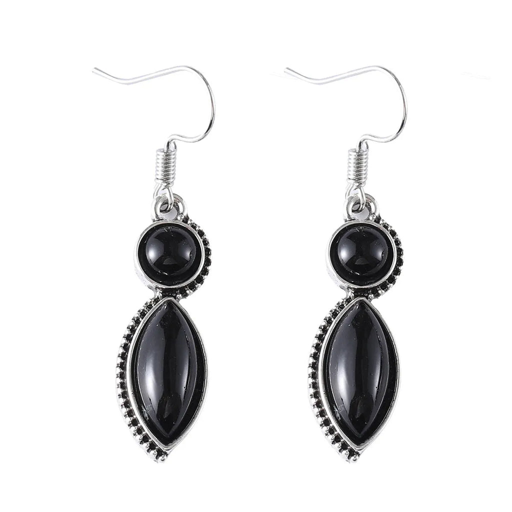 A pair of geometric vintage earrings with a black and purple electroplated finish, showing a pendant design with round elements.