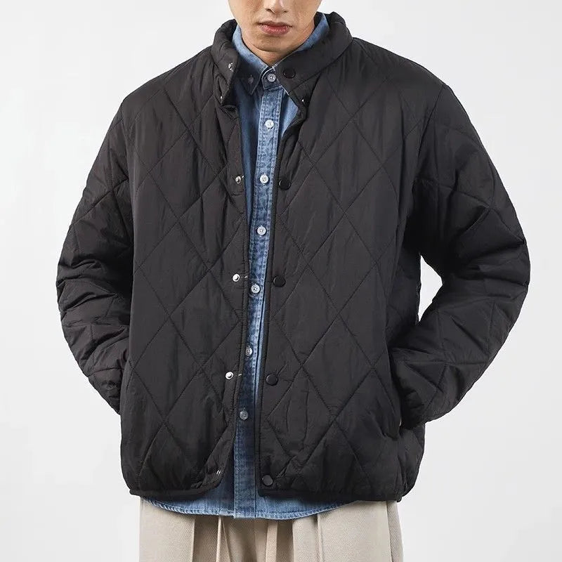 Men's black diamond quilted winter jacket with a loose, longline fit and zip-up front.
