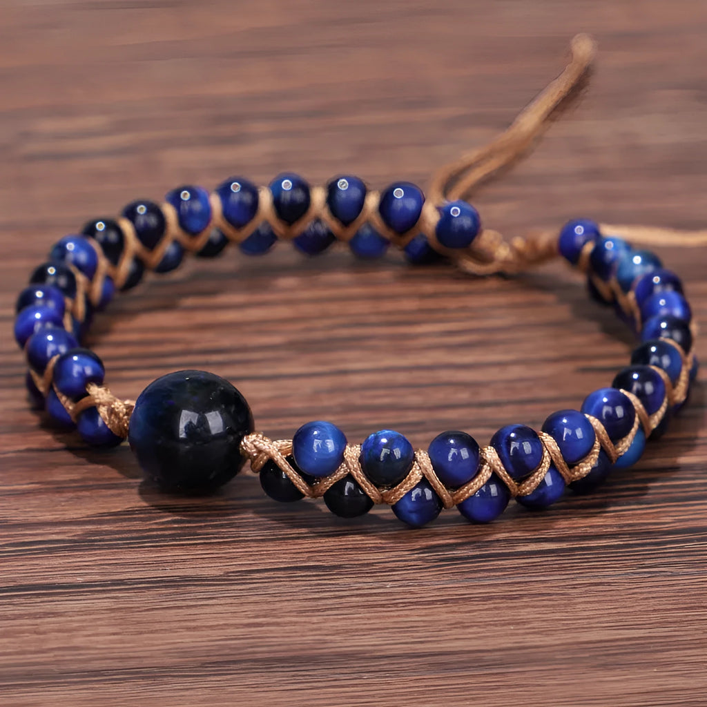 Handmade woven pull bracelet in blue Tigereye or amethyst with geometric design on wrist.