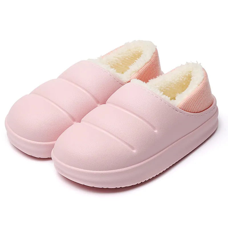 Green waterproof EVA garden slippers with plush lining and a non-slip sole, shown on a wooden deck.