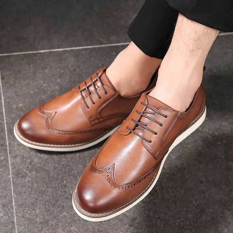 Men's black slip-on business casual shoes with round toe and carved sole detail on a white background.