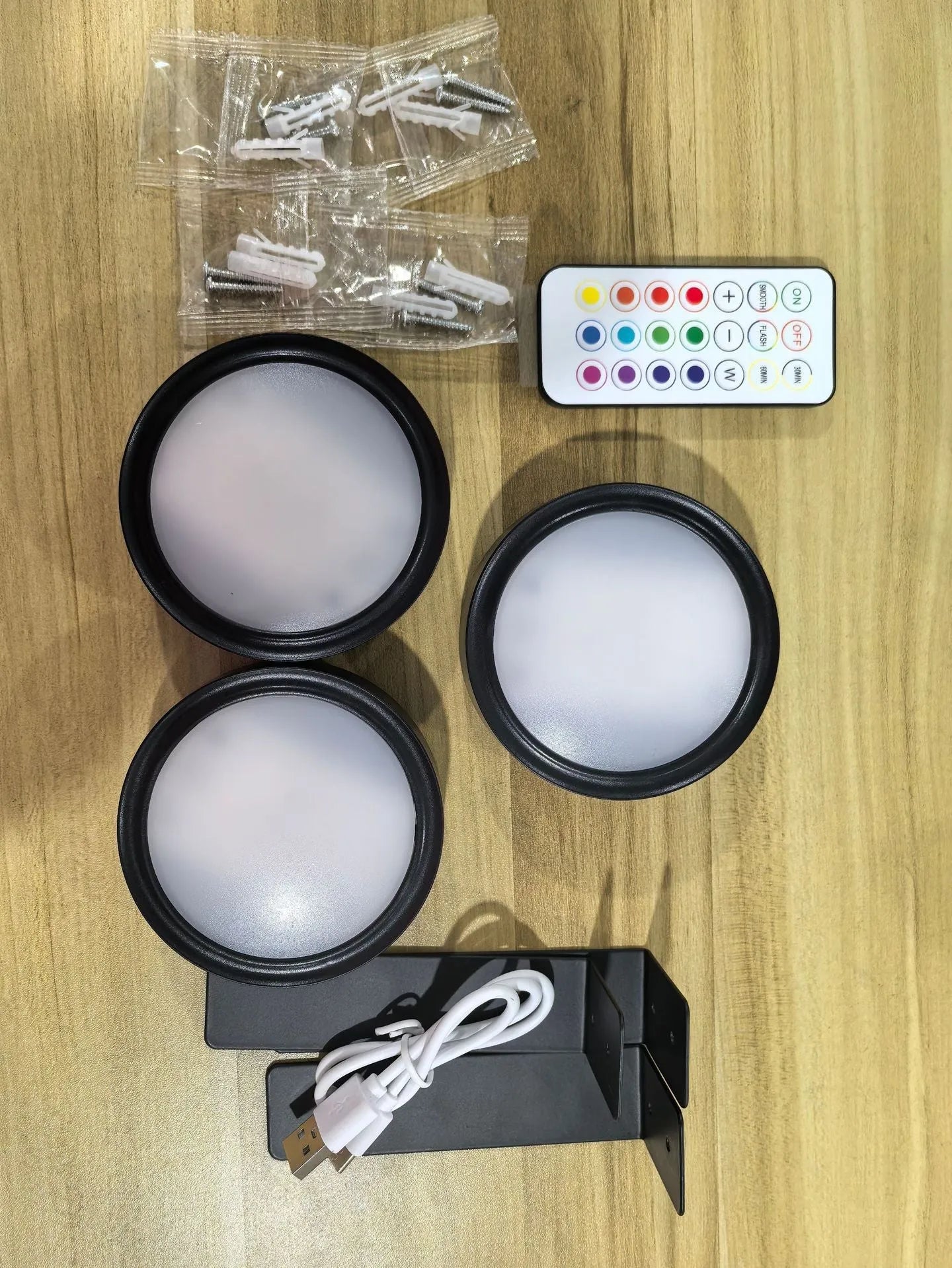 Wireless rechargeable LED painting lamp with magnetic belt attached to a metal frame, remote control nearby.
