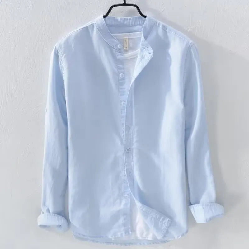 Man wearing a loose-fit light blue long sleeve cotton linen casual shirt.