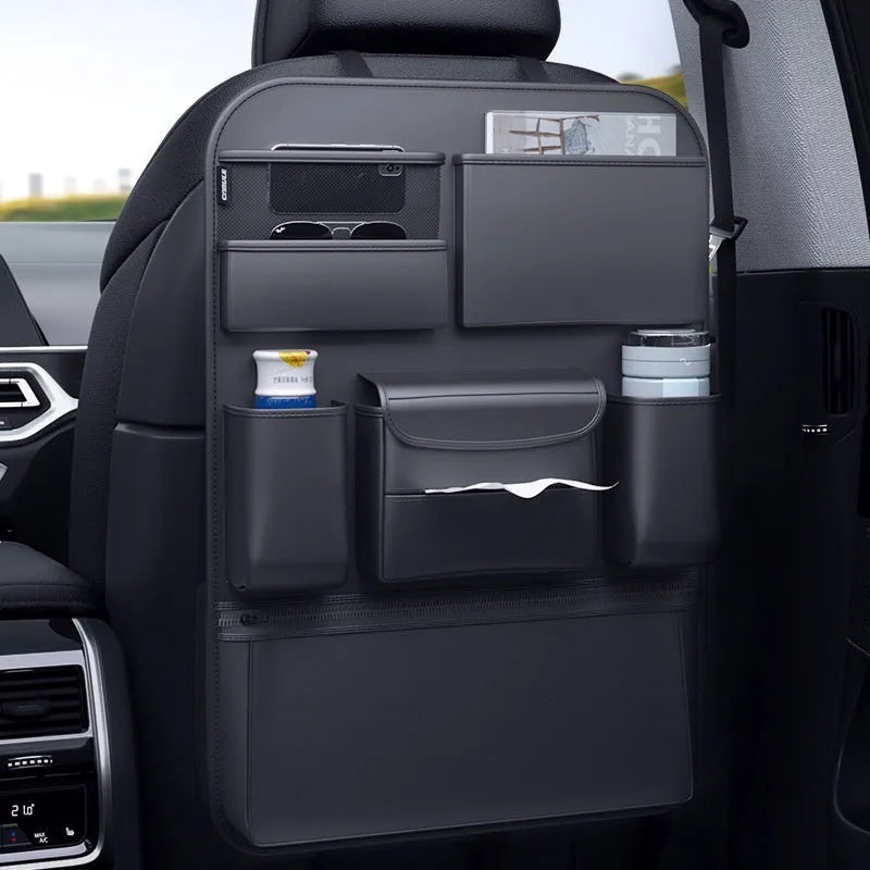 Black leather car seat back hanging storage bag with carrying handle shown in vehicle