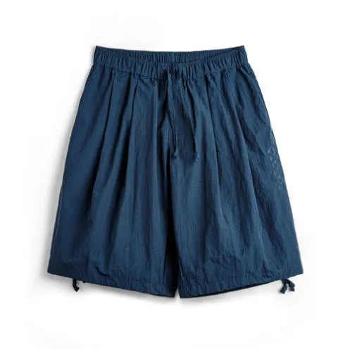Prussian blue men's loose fit beach shorts with embroidery on lightweight nylon fabric.