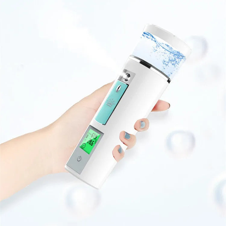 White rechargeable USB portable facial moisturiser spray 15cm by 4.5cm on a table