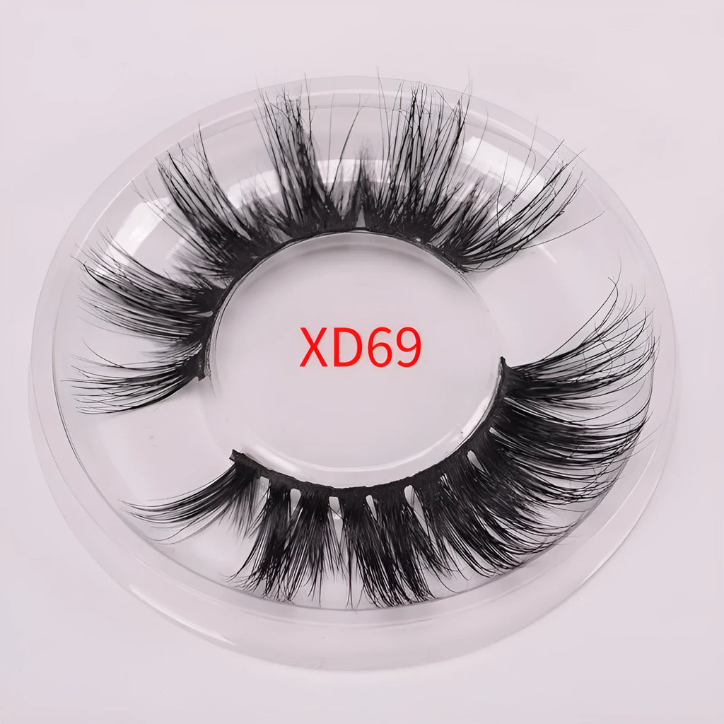 A pair of 5D volume false eyelashes made from real mink hair, with an application brush and storage case.