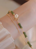 Natural olivine stone bracelet with Chinese double layer design and Bells of Ireland charms
