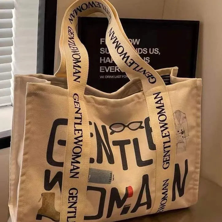 Large canvas tote bag with printed design, shown in multiple colour and pattern options.