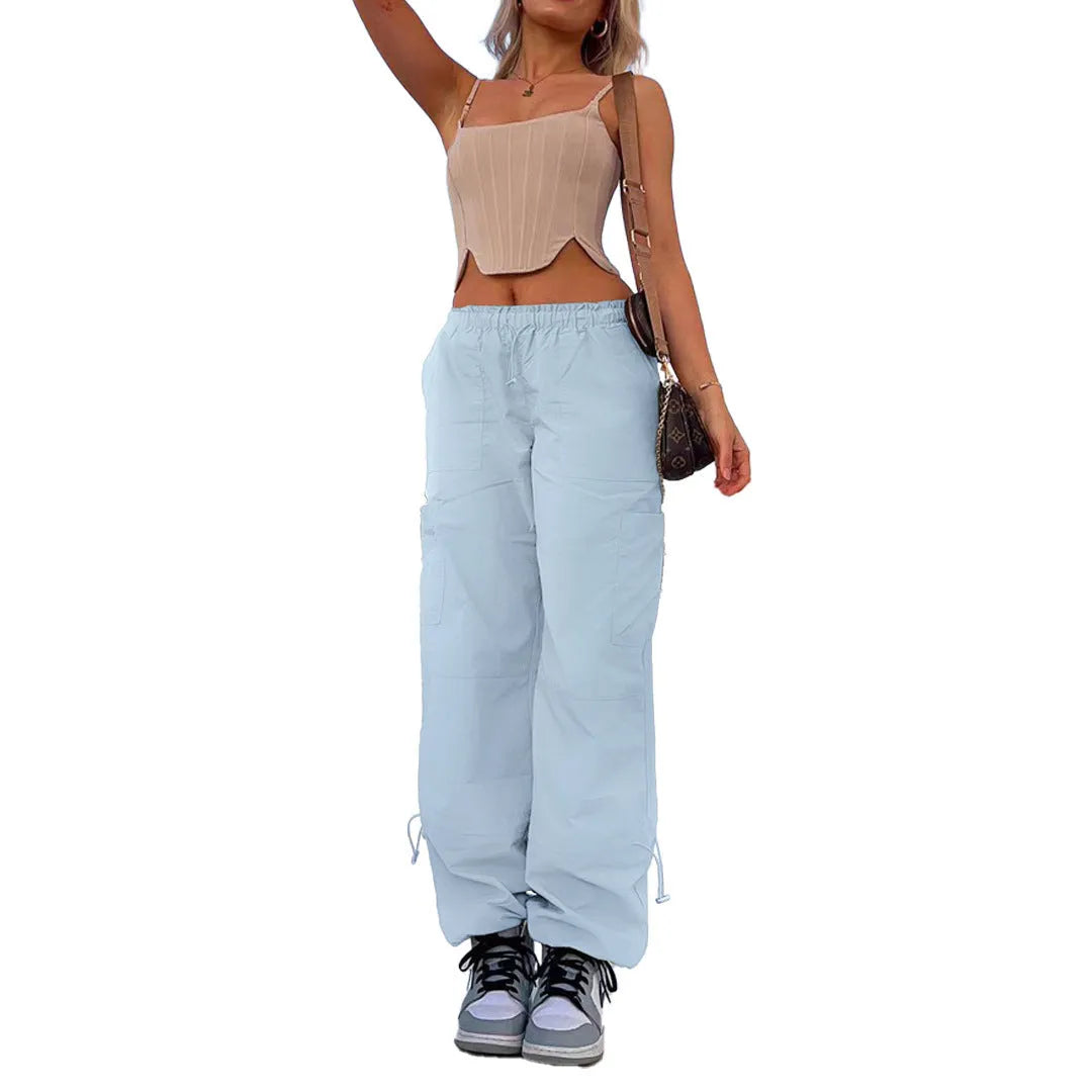 Man wearing loose grey straight-leg cargo casual pants with multiple pockets.