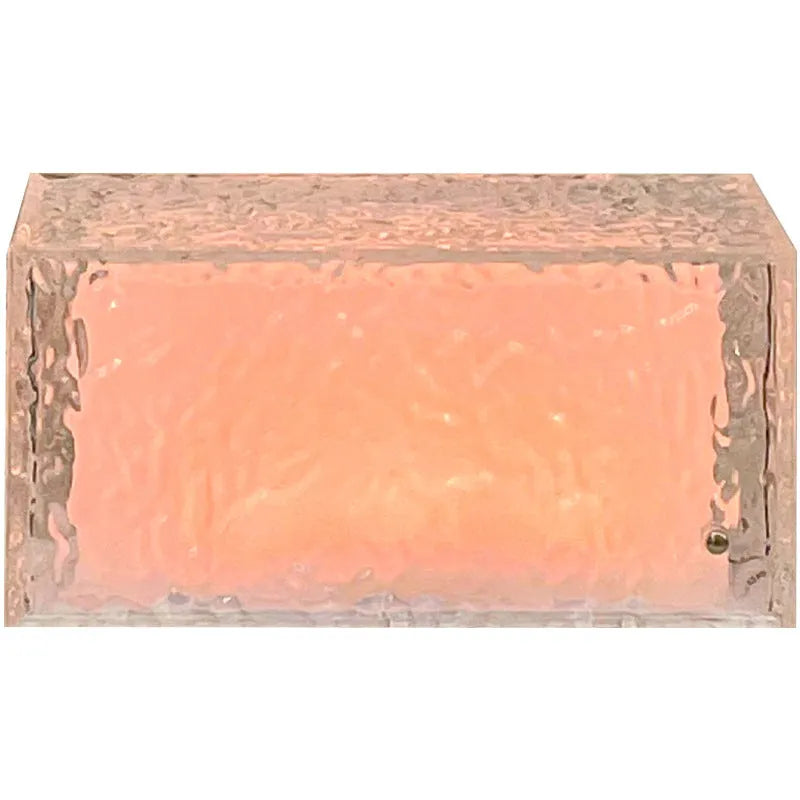 Small clear acrylic cube night light with colour-changing LED mood lighting on a wooden surface.