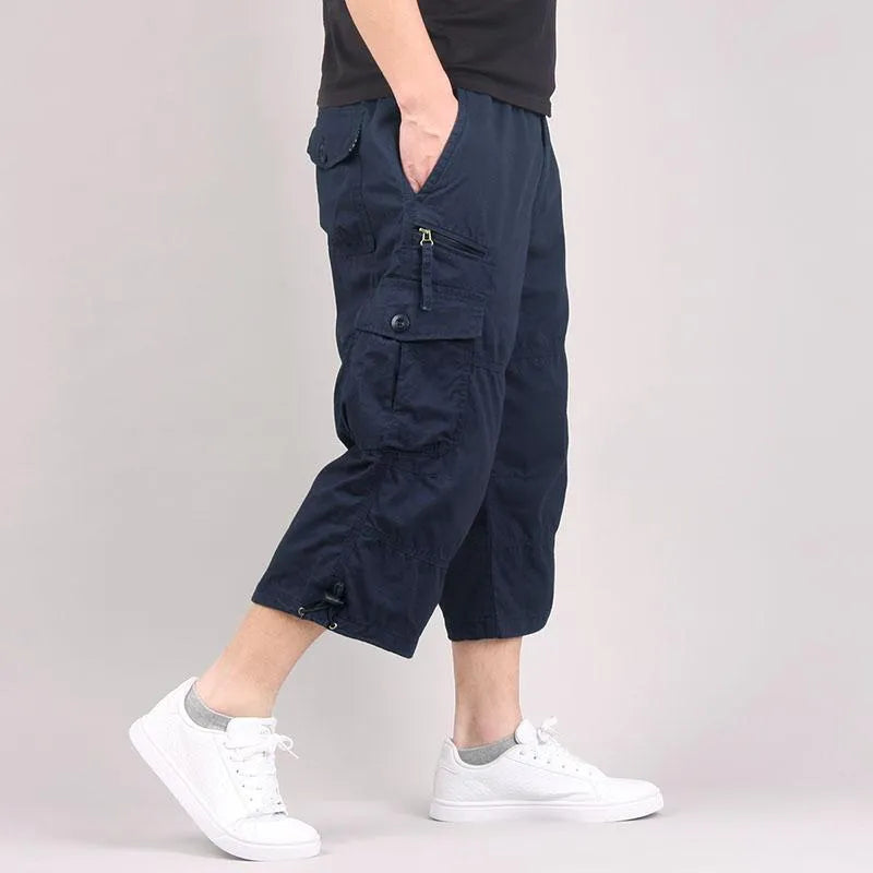 Men's loose-fit cotton cropped casual pants in khaki colour, shown on a size chart.