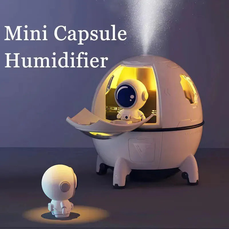 Light purple astronaut-themed USB humidifier with colourful LED lights on desktop