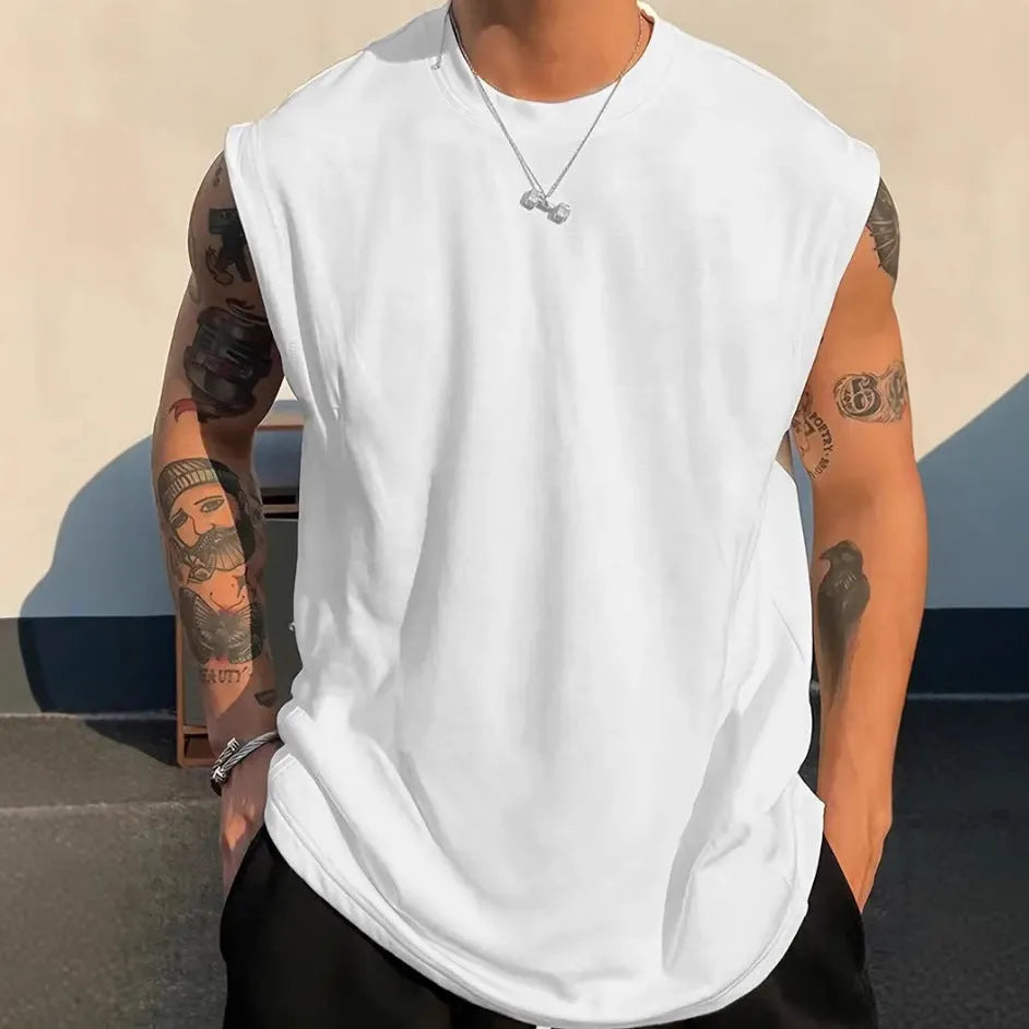 Men's loose solid colour sleeveless cotton tank top on a hanger, shown in a light apricot shade.