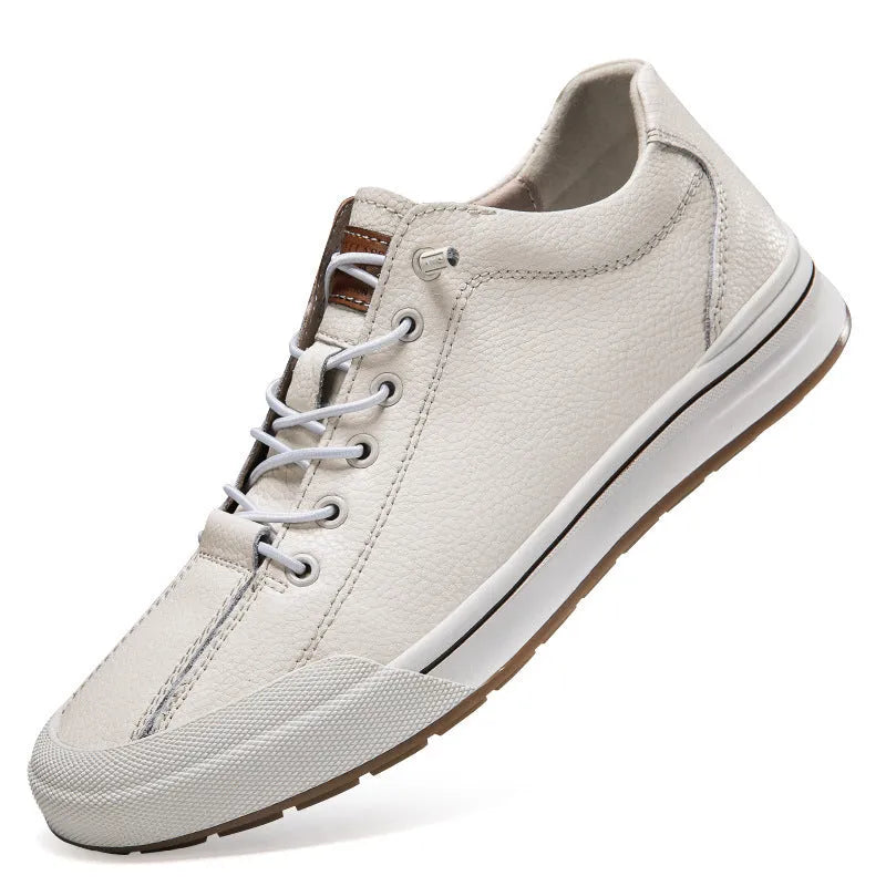 Men's white leather casual shoes with flat heel and round toe on a plain background