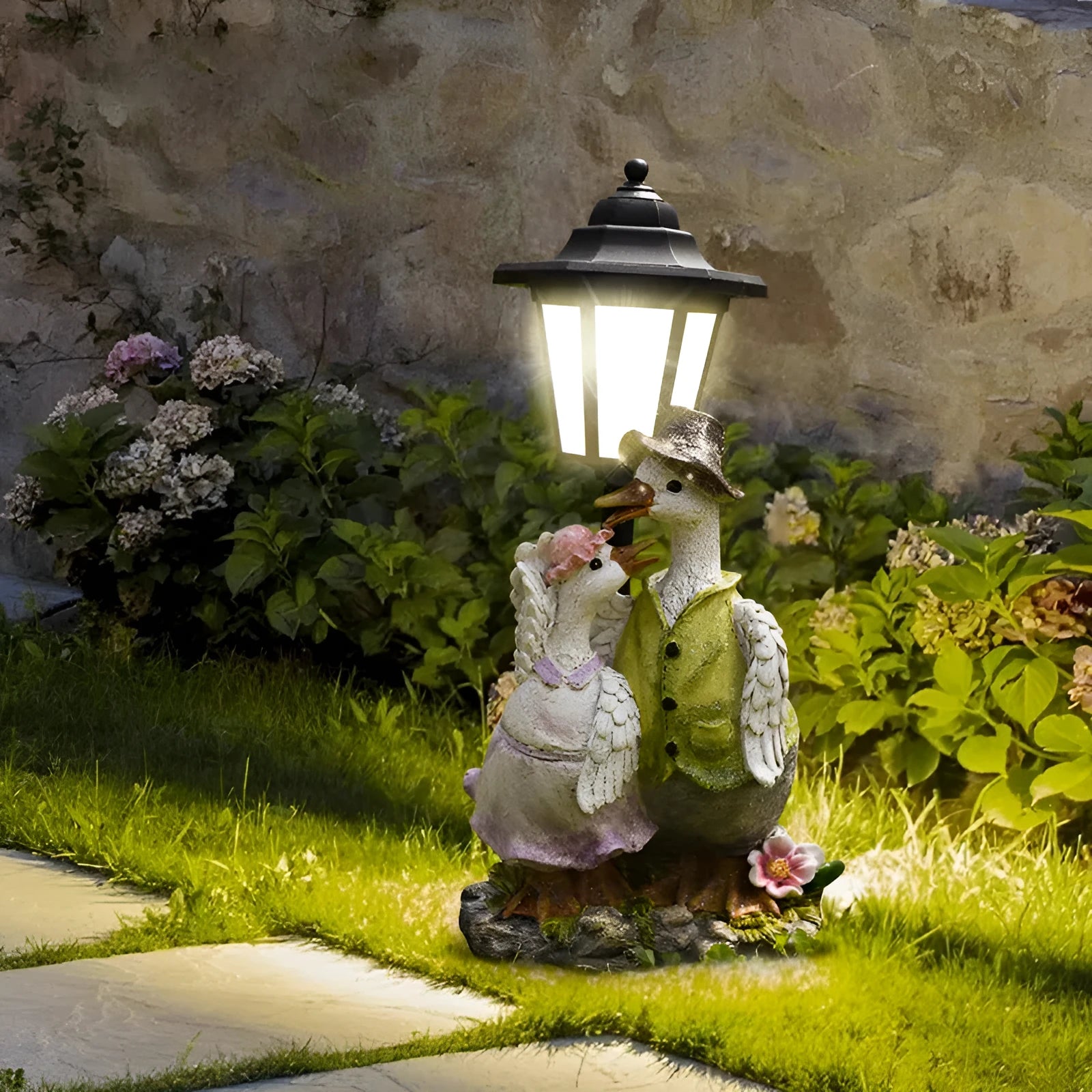 Solar hexagonal garden lamp with decorative resin figurine on plastic base for outdoor pathway lighting