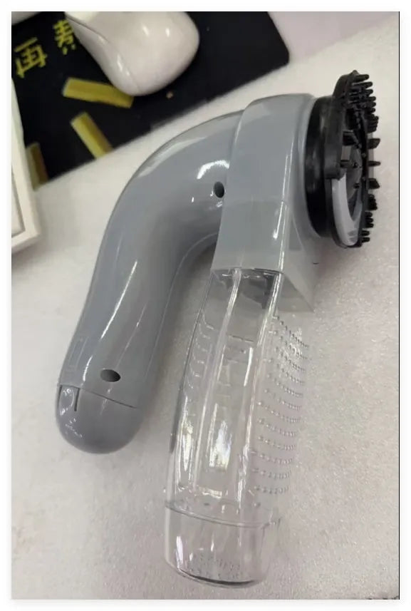 Grey cordless handheld pet hair vacuum grooming brush with soft rubber head
