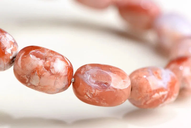 Natural cherry agate barrel bead bracelet with 10x14mm geometry and Ruyi design elements