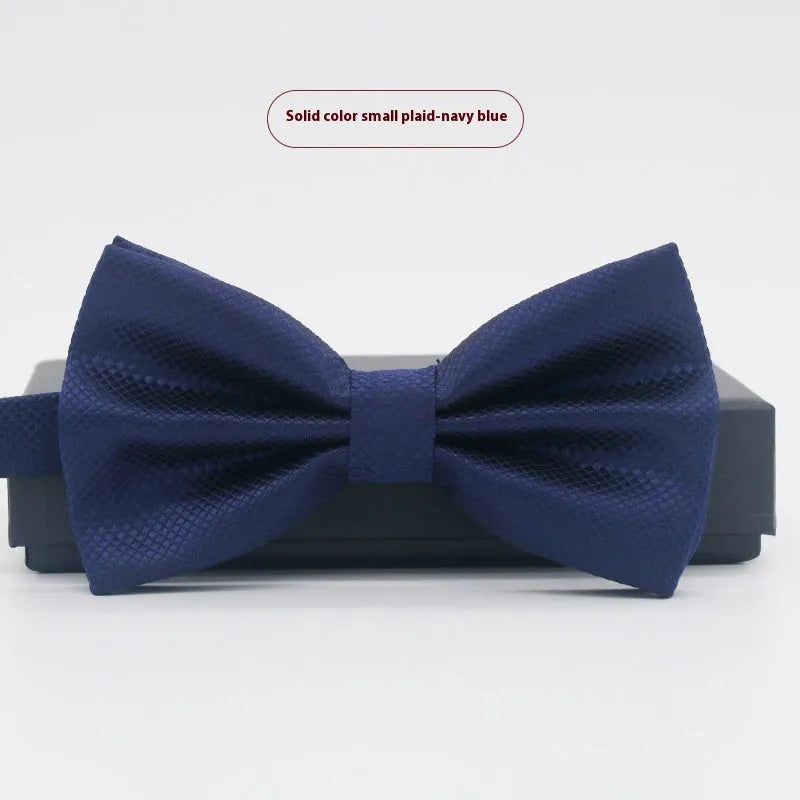 Men's flat head style polyester bow tie in a solid colour, shown with adjustable neck strap.