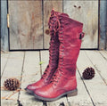 Women's black cross-strap knight boots made from artificial PU, side view.