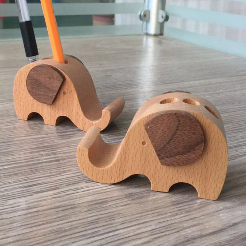 Beech wood mobile phone holder stand with coin slot and decorative carving.