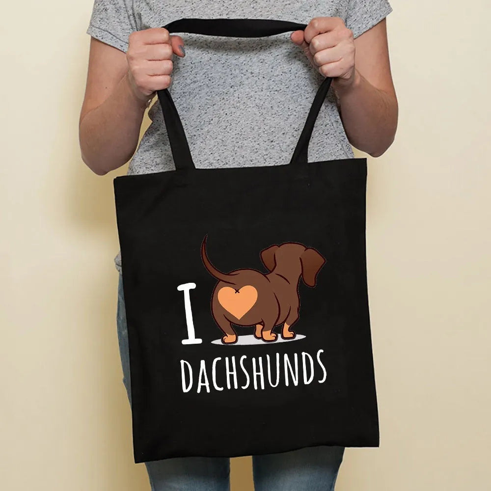 Sausage dog printed canvas bag in black with white dog design on front, sturdy tote for everyday use