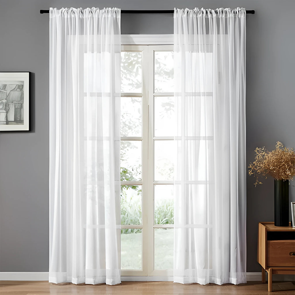 Modern pure colour cotton linen curtain in black hanging vertically with light transmission visible