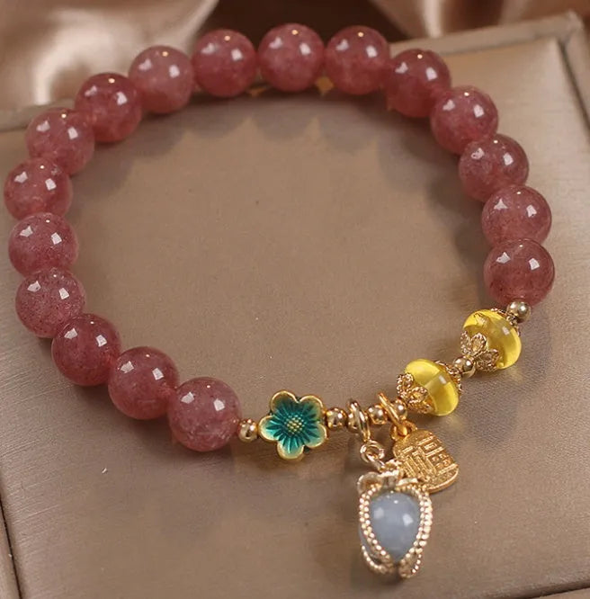 Red strawberry quartz beaded bracelet with alloy metal and rhinestone details