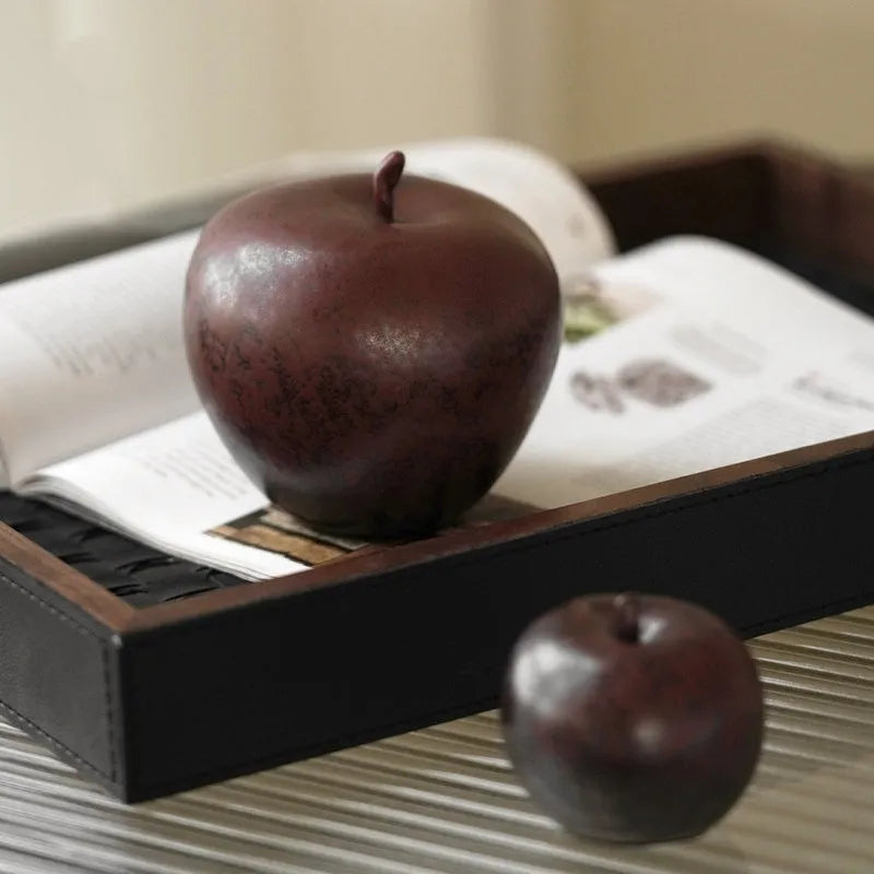 Ceramic apple decoration ornament on a desk, shown in large and small size options.