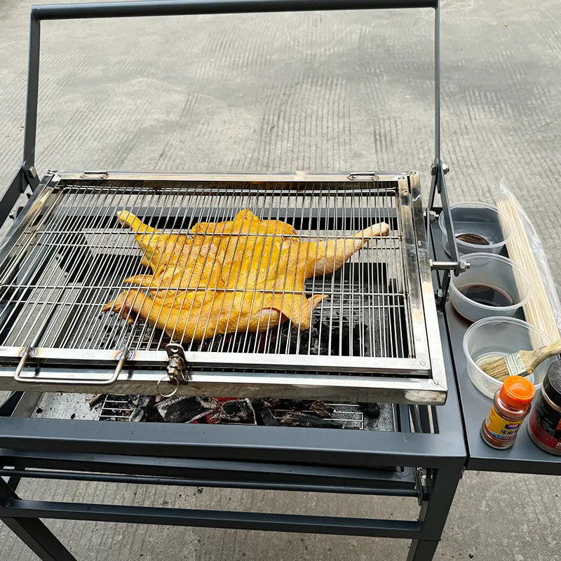 Large foldable portable charcoal grill oven set up in a garden