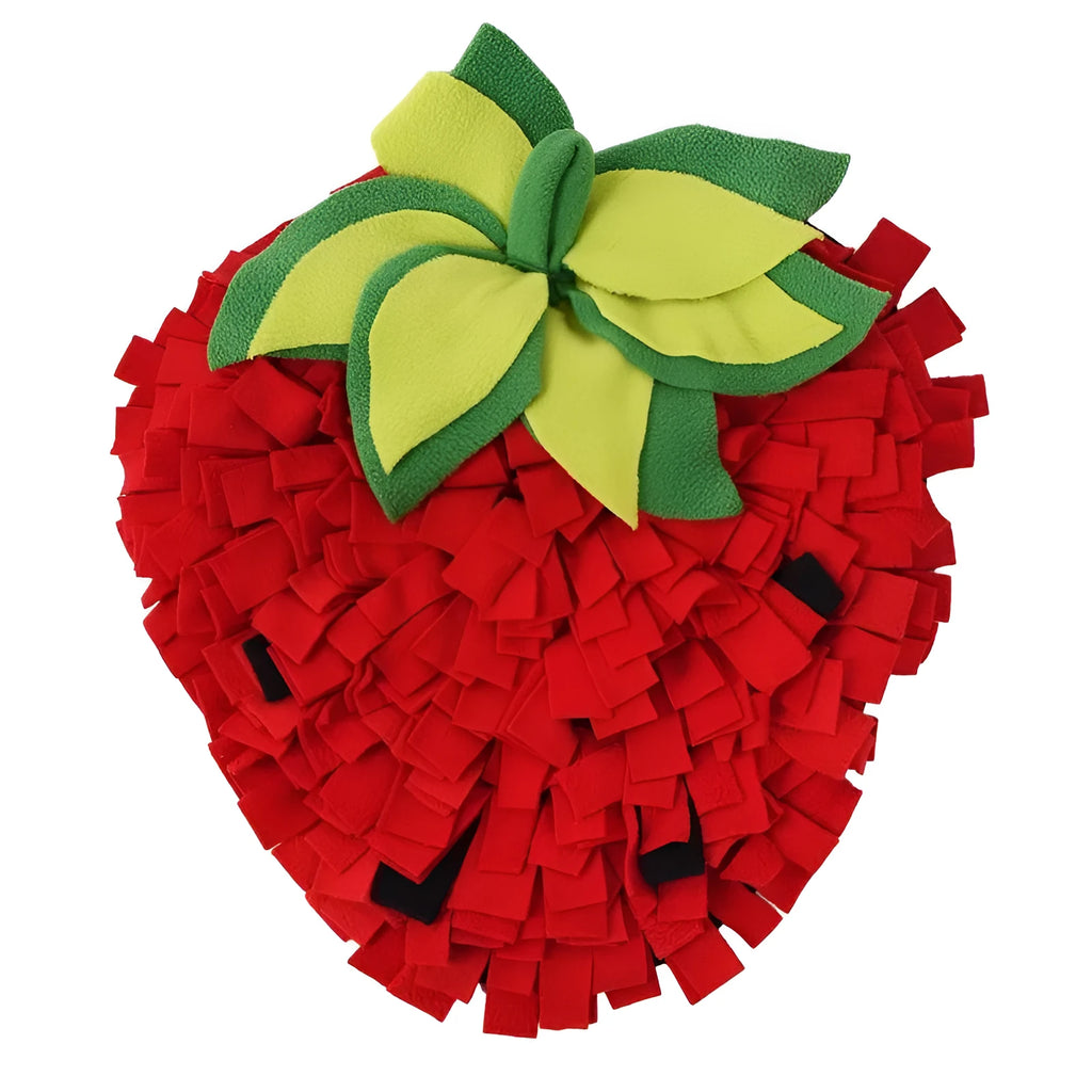 Red and green strawberry-shaped snuffle mat for dogs and cats on a floor.