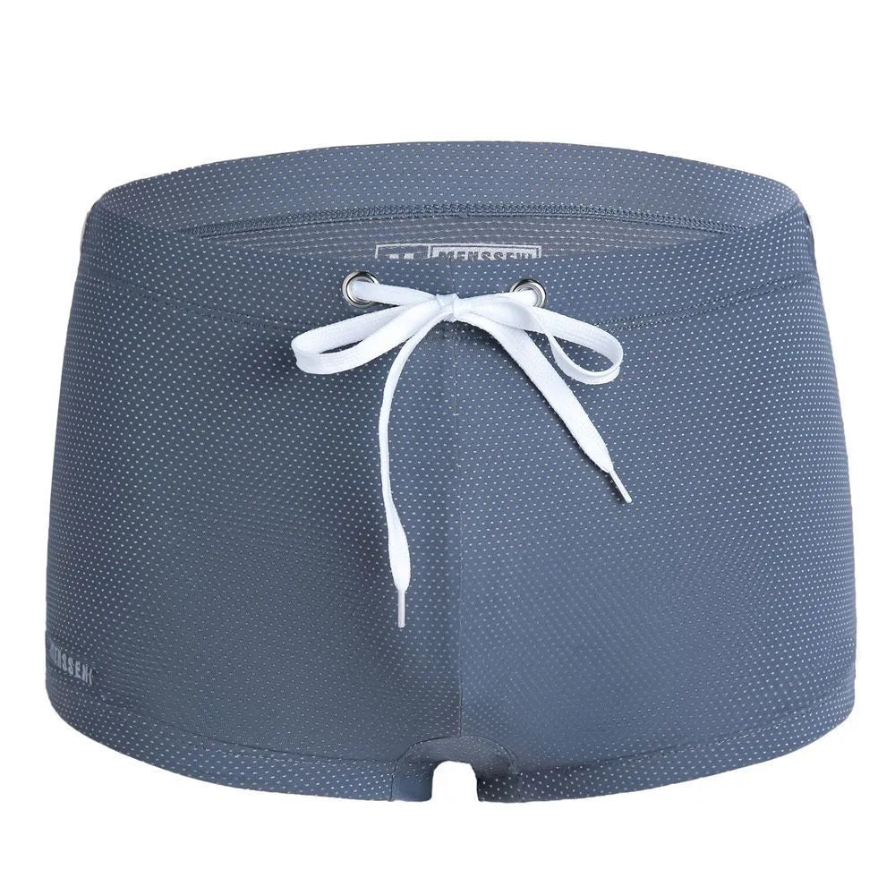 Men's low waist boxer style nylon swimming trunks in multiple solid colours