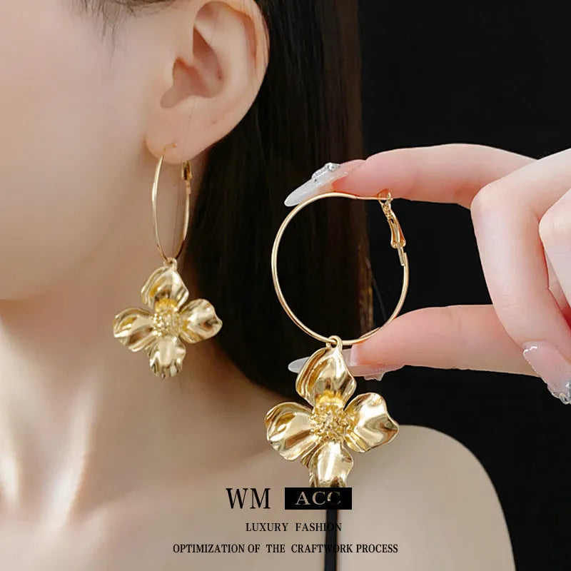 Silver needle metal flower earrings with geometric floral design in gold or silver colour