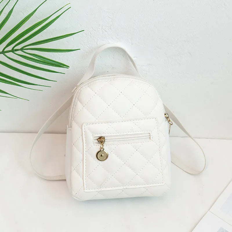 Hard white Korean style embroidered girls backpack showing sandwich pocket and soft carry handle.