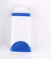 Blue reusable pet hair removal brush with a self-cleaning base, placed on a grey sofa.